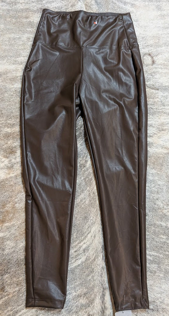 Zenana Brown Vegan Leather Pants on a stone grey surface