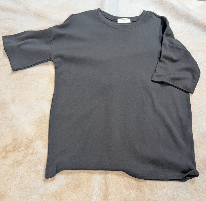 Gray t-shirt on a beige surface