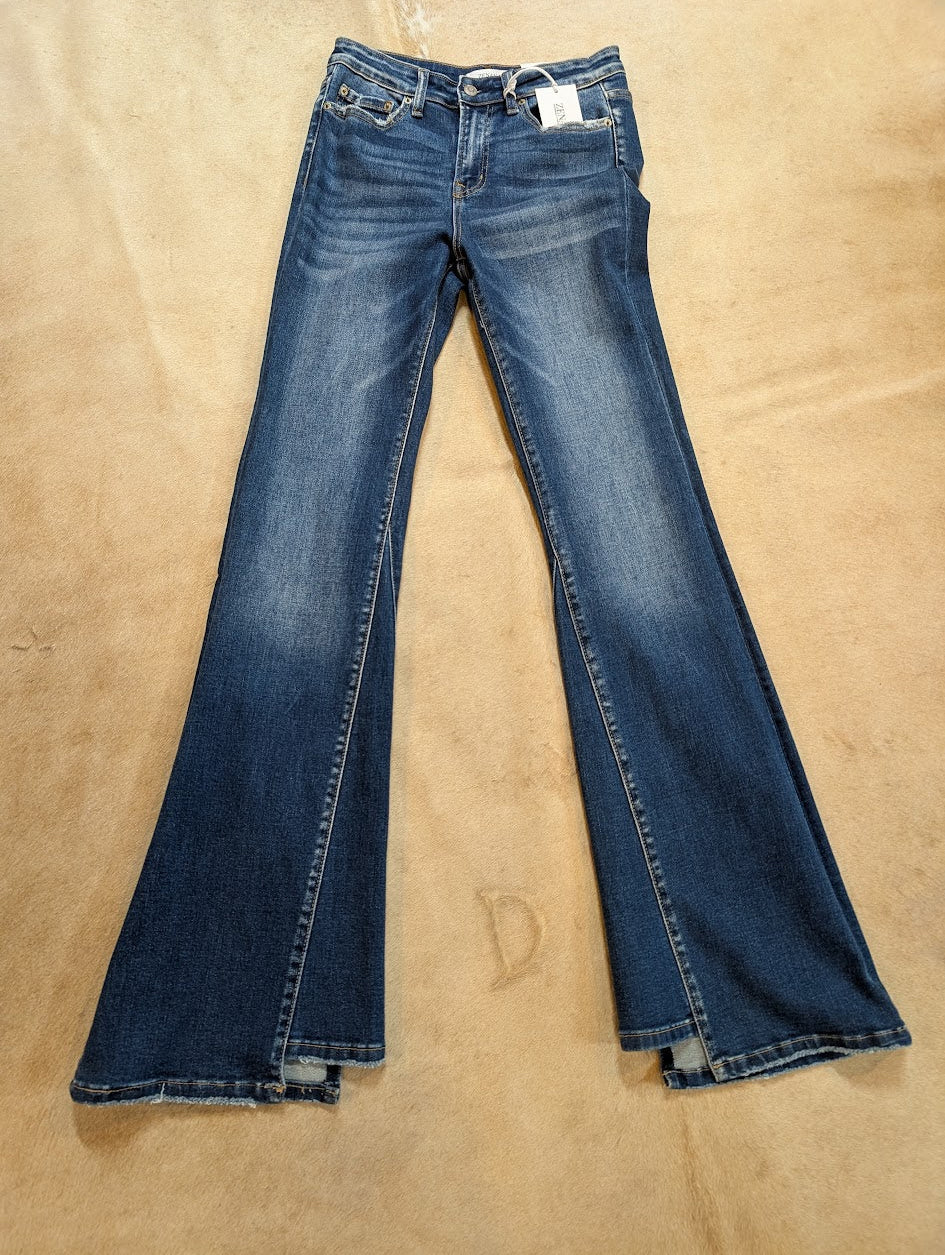 Pair of blue jeans on a beige surface