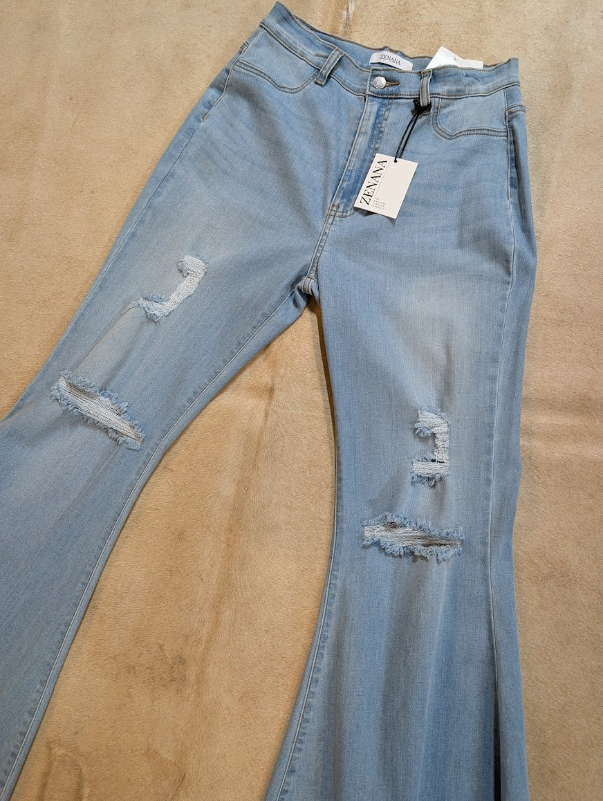 Blue jeans with distressing details on a beige surface Zenana Brand