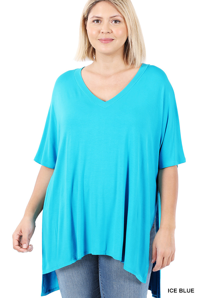 Woman wearing a turquoise tunic with a plain background