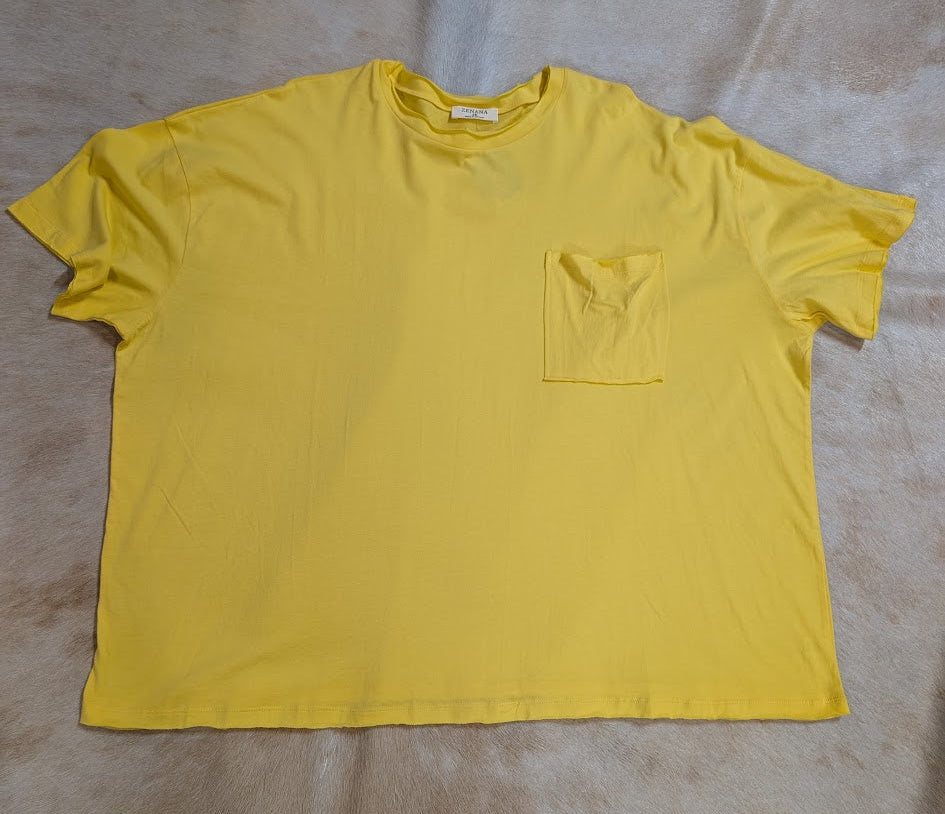 Yellow oversize pocket T-shirt with a textured background.