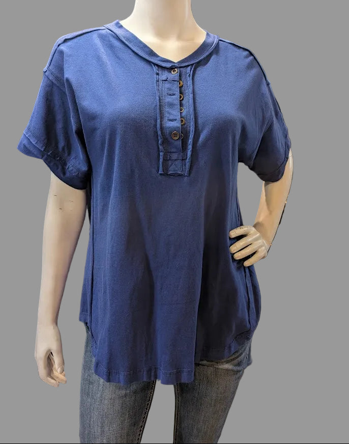Mannequin wearing a blue shirt with buttons and jeans with a grey background