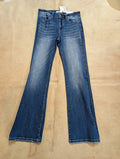 Zenana women’s medium wash mid-rise bootcut stretch denim jeans laid flat on rustic background