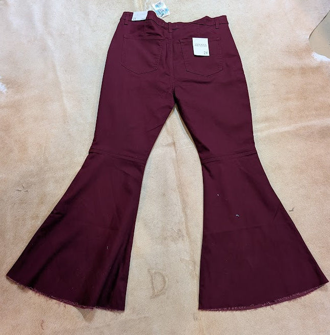Maroon bell-bottom pants on a beige surface