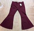 Zenana women’s plus size burgundy high rise bell bottom flare jeans laid flat on rustic background