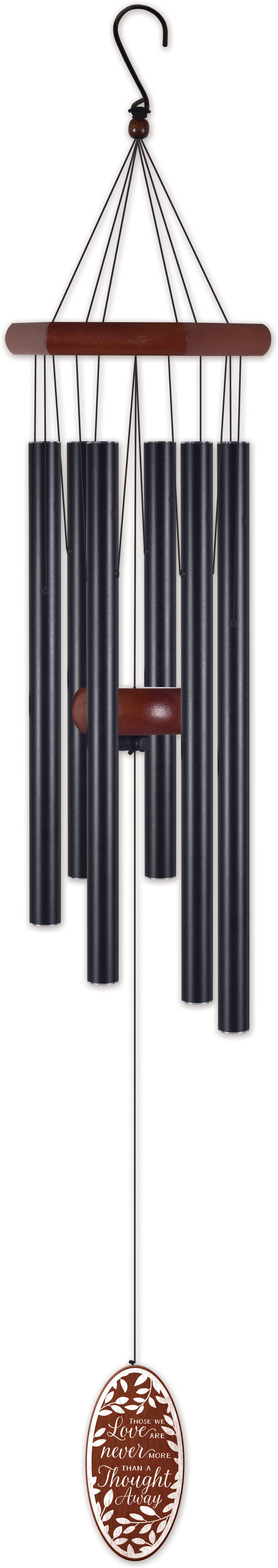 A wind chime with multiple dark metal tubes hanging from a wooden bar, suspended by cords from a top hook, with a decorative oval metal ornament below.