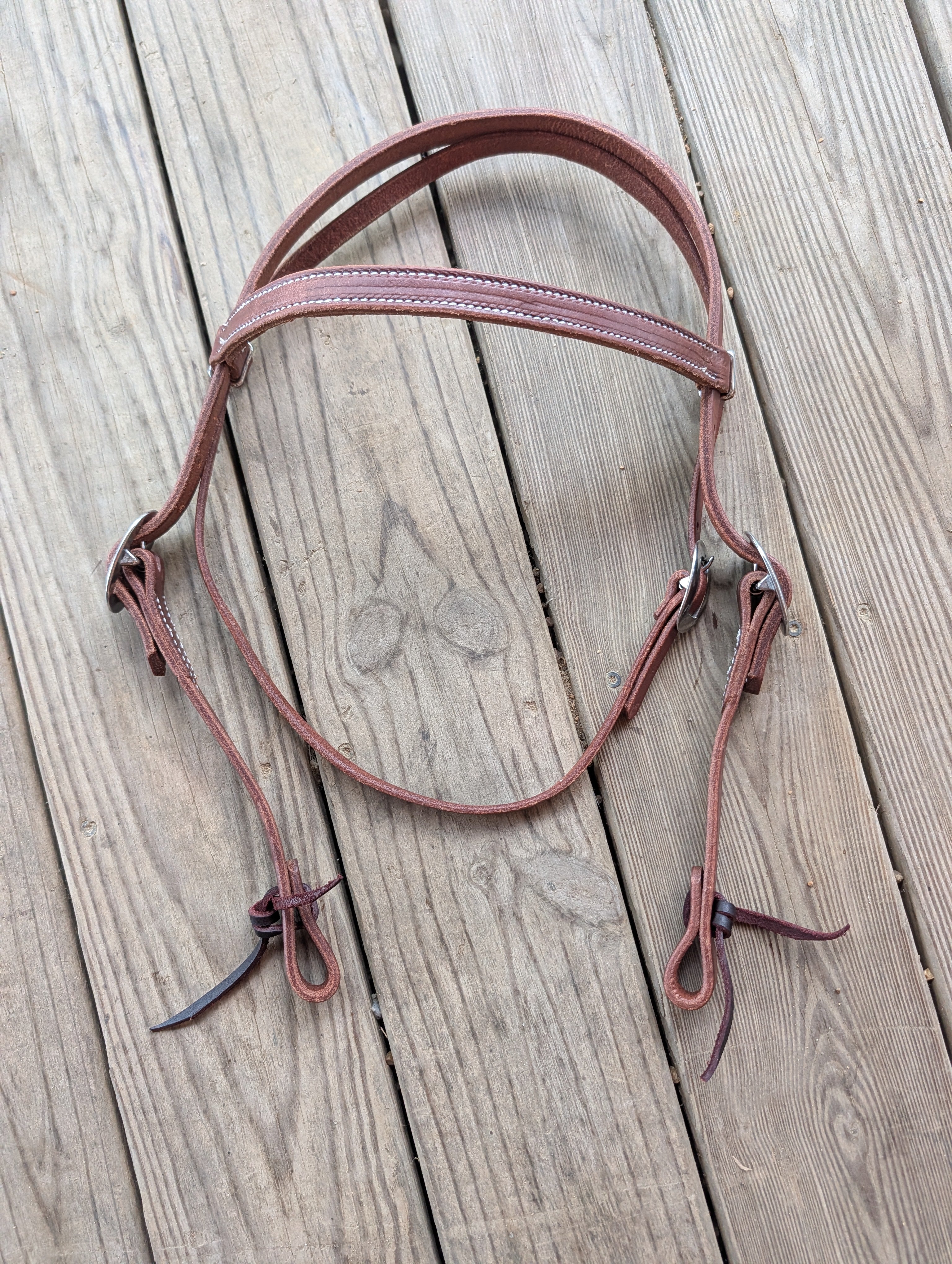 A Amish made brown leather browband headstall with silver buckle hardware