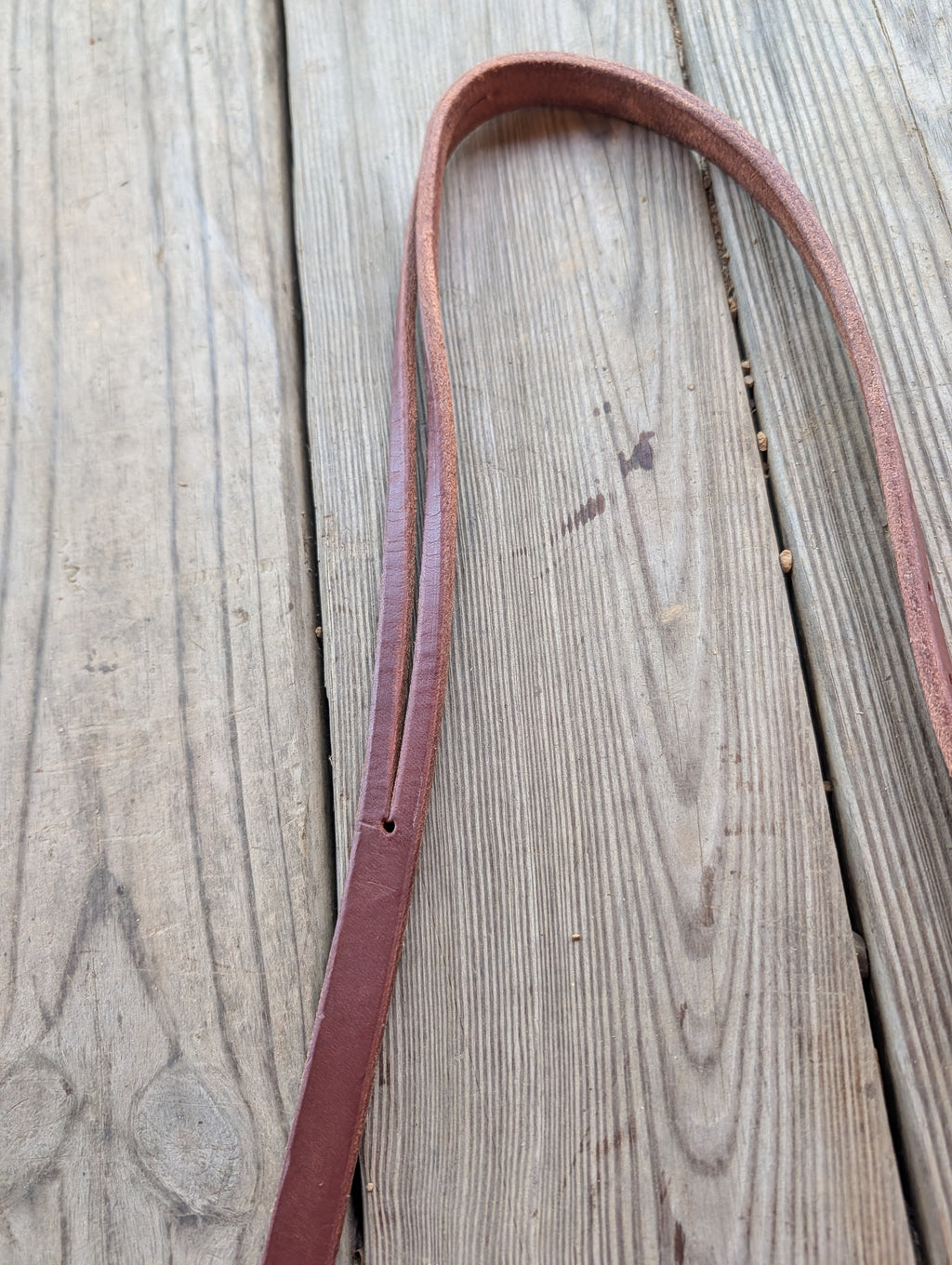 A up-close of a brown amish made leather split ear headstall.