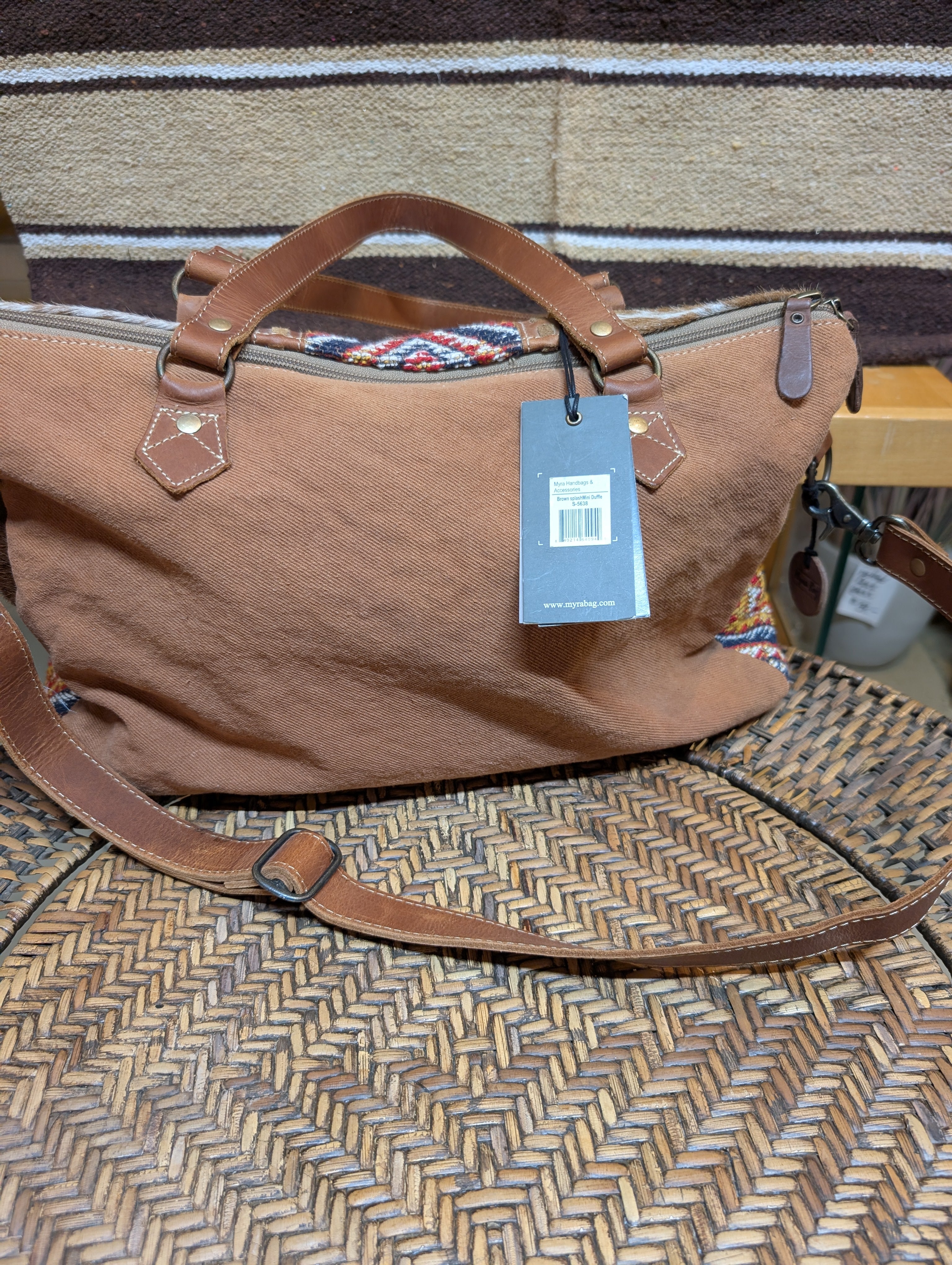 Brown bag with a tag on a woven surface