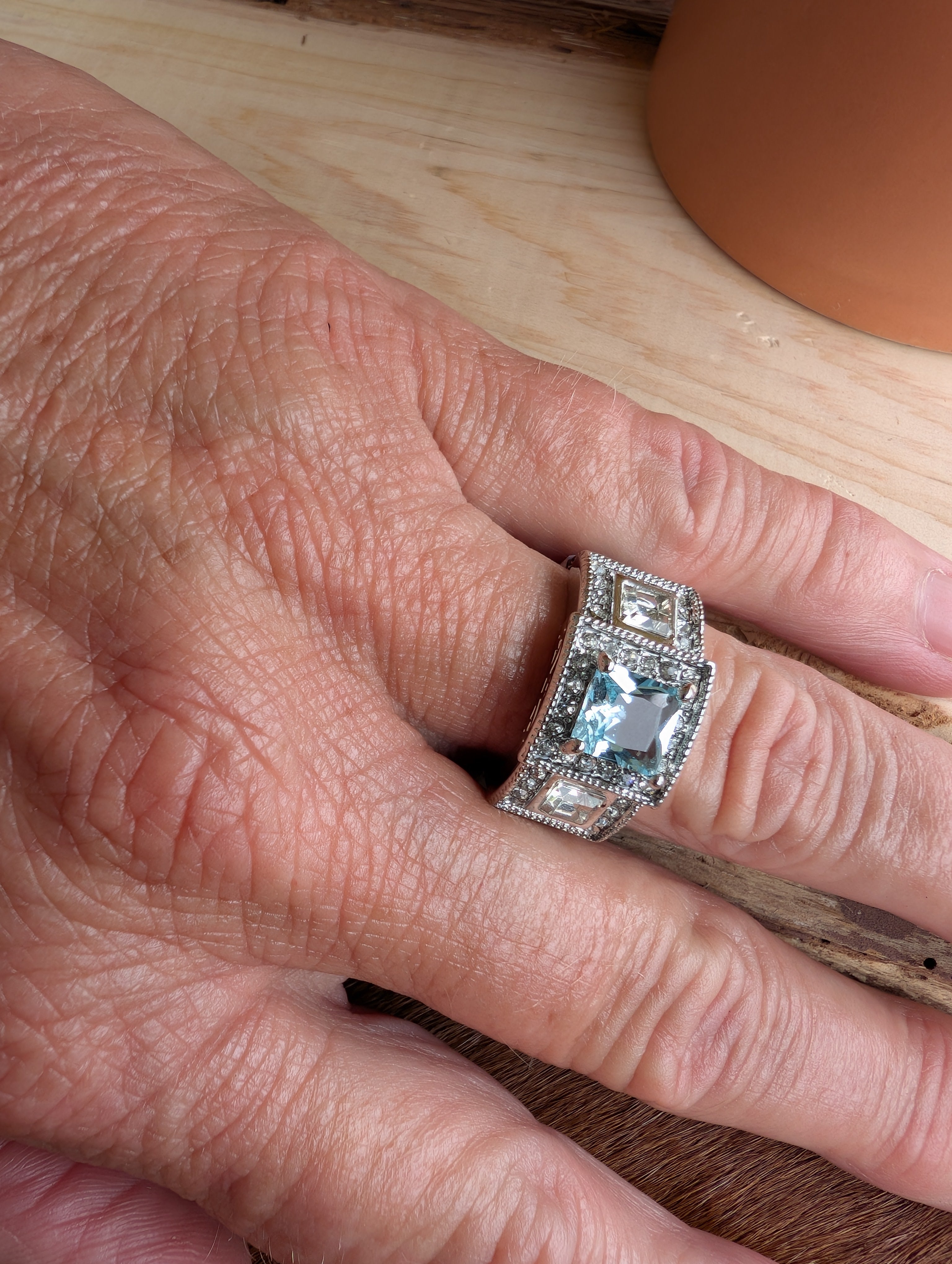 Boho fashion ring styled on hand with casual outfit
