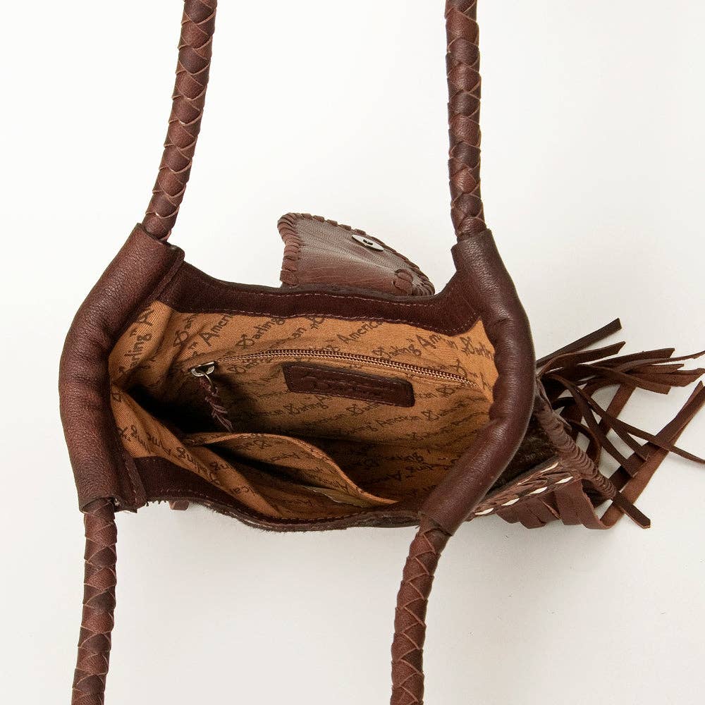 Brown leather handbag with braided handle on a white background