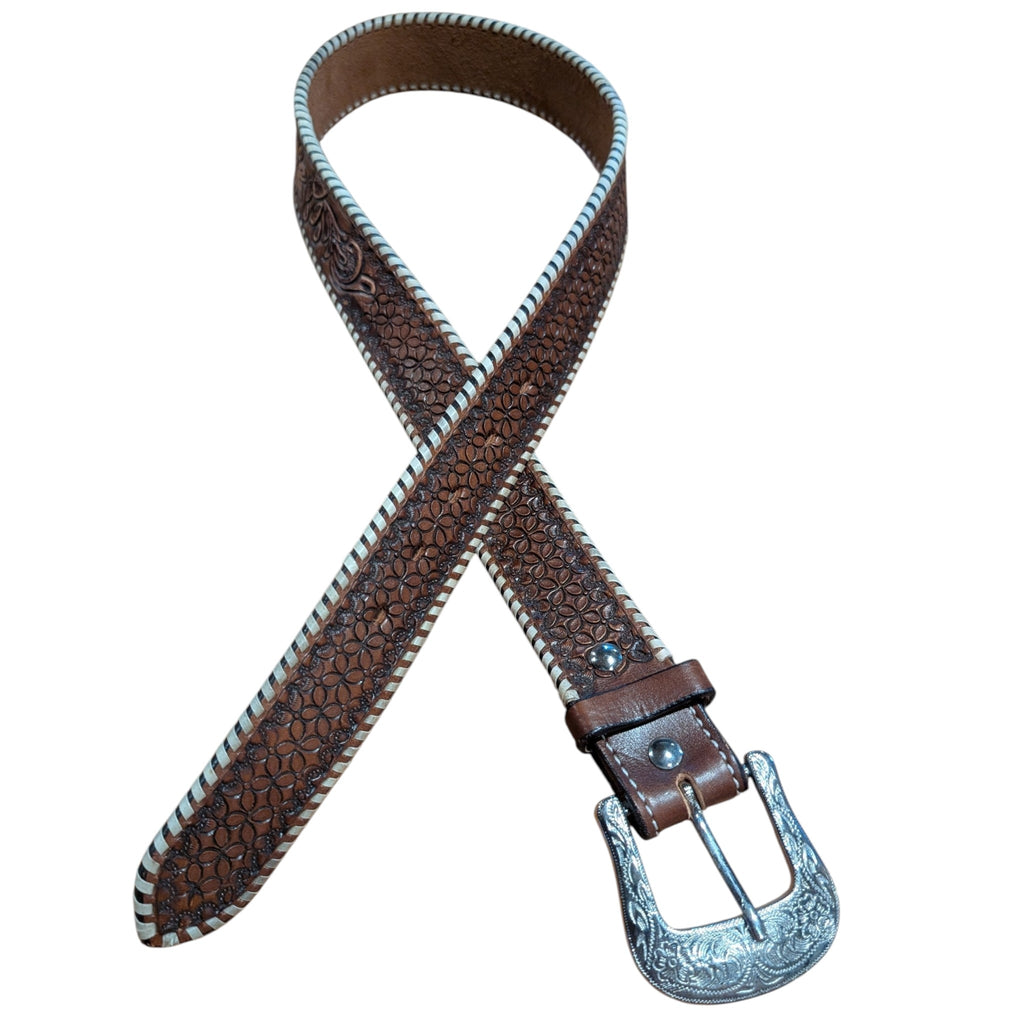 Close-up view of the Circle Y Women's Desert Edge Leather Belt showing the silver etched buckle, floral cactus tooling, and white whipped rawhide edges