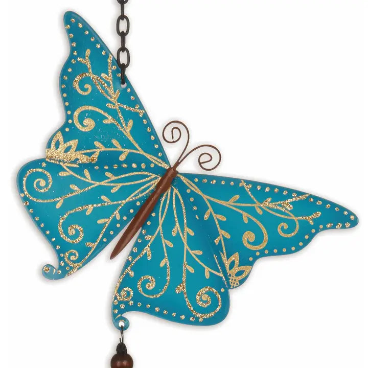 Decorative butterfly with blue wings and gold patterns that is the top of a windchime