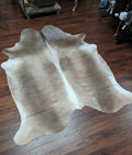 Cowhide named Titan showing the grey palomino coloring with the white spine and edge accents.