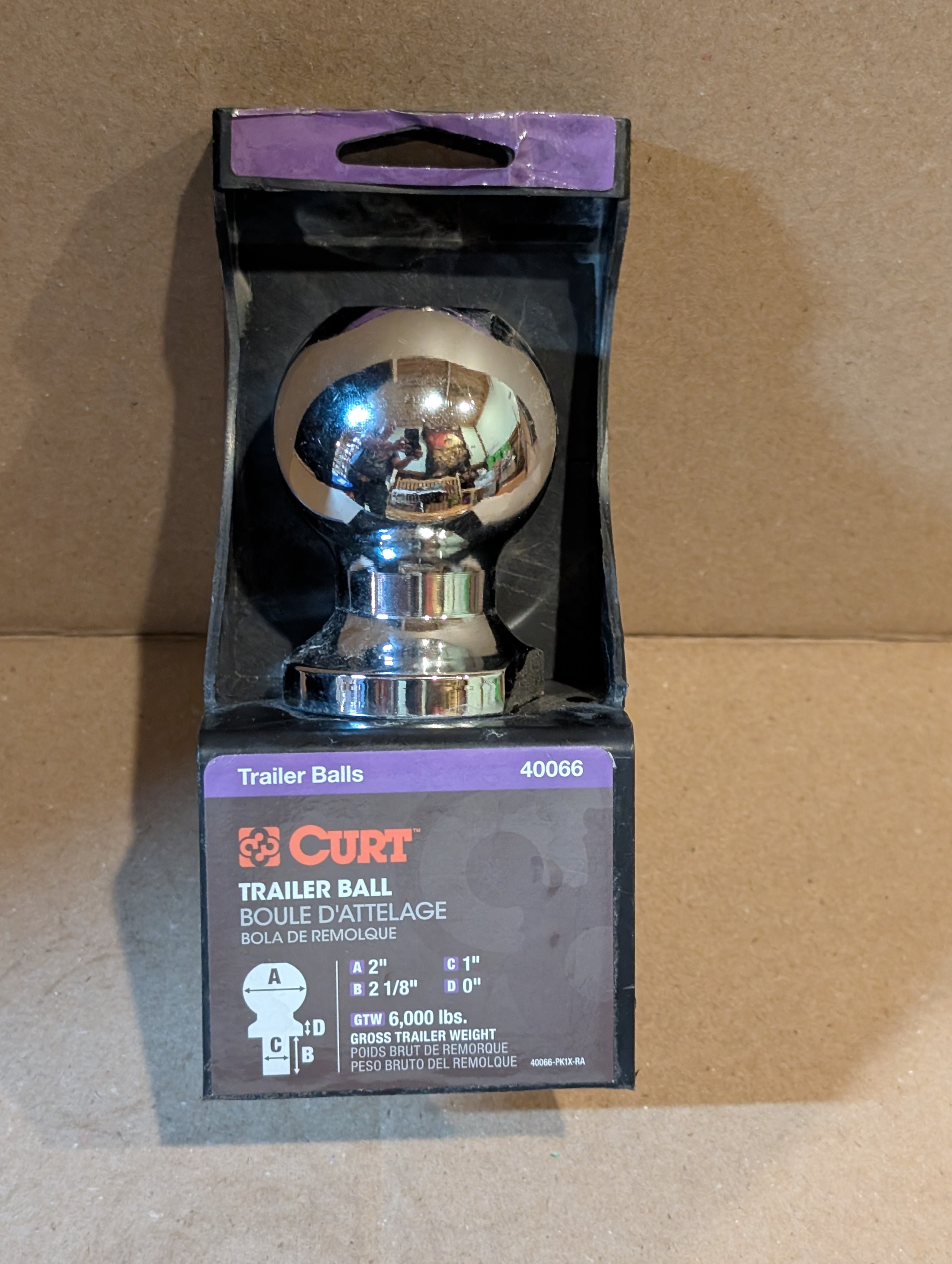 Retail package of a Curt 2" chrome trailer ball showing a 6,000 lb capacity and 1" shank diameter.