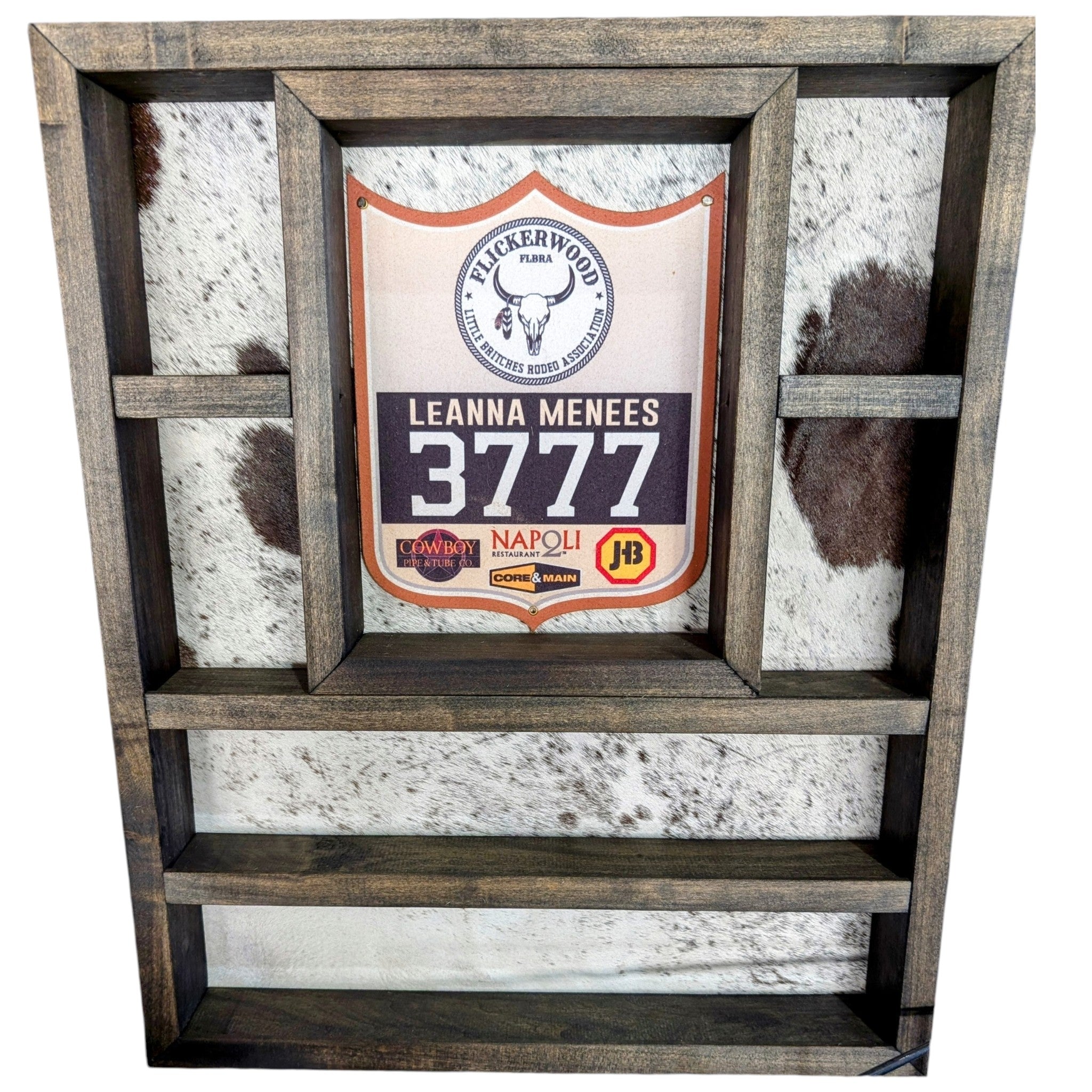 A rustic handcrafted burnt hickory  wooden belt buckle and knife display with genuine cowhide.