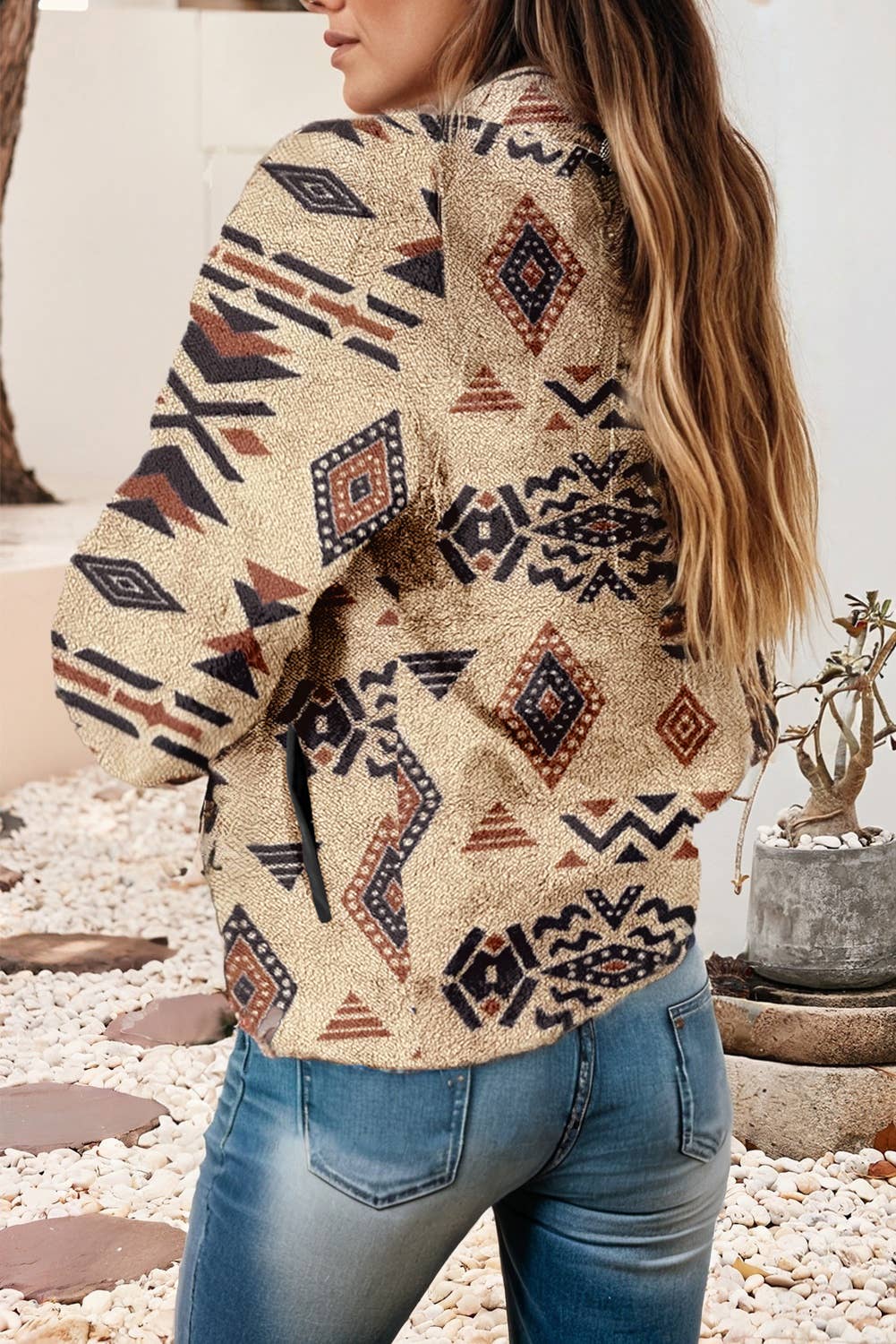 Person wearing a patterned jacket with a blurred background