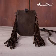 Brown leather bag with fringes on a wooden surface, featuring the Montana West brand.