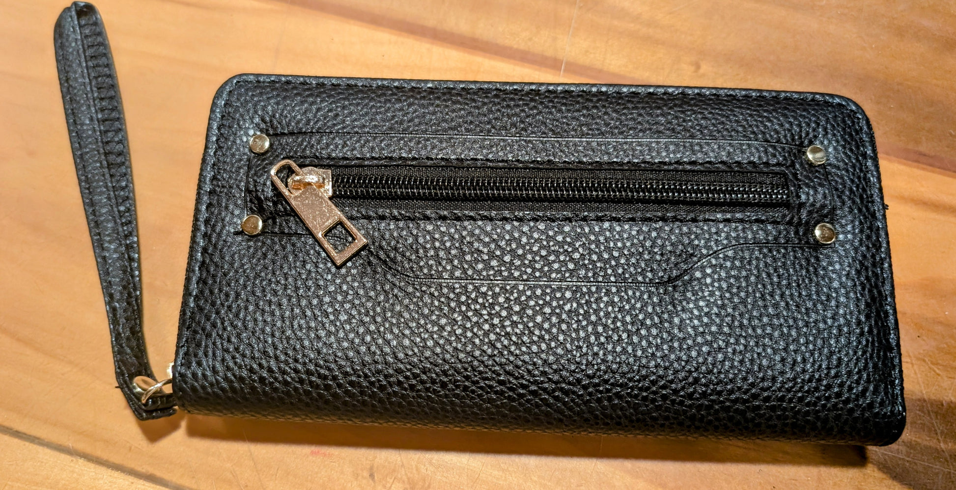 Compact hands-free wristlet wallet made of durable faux leather in black