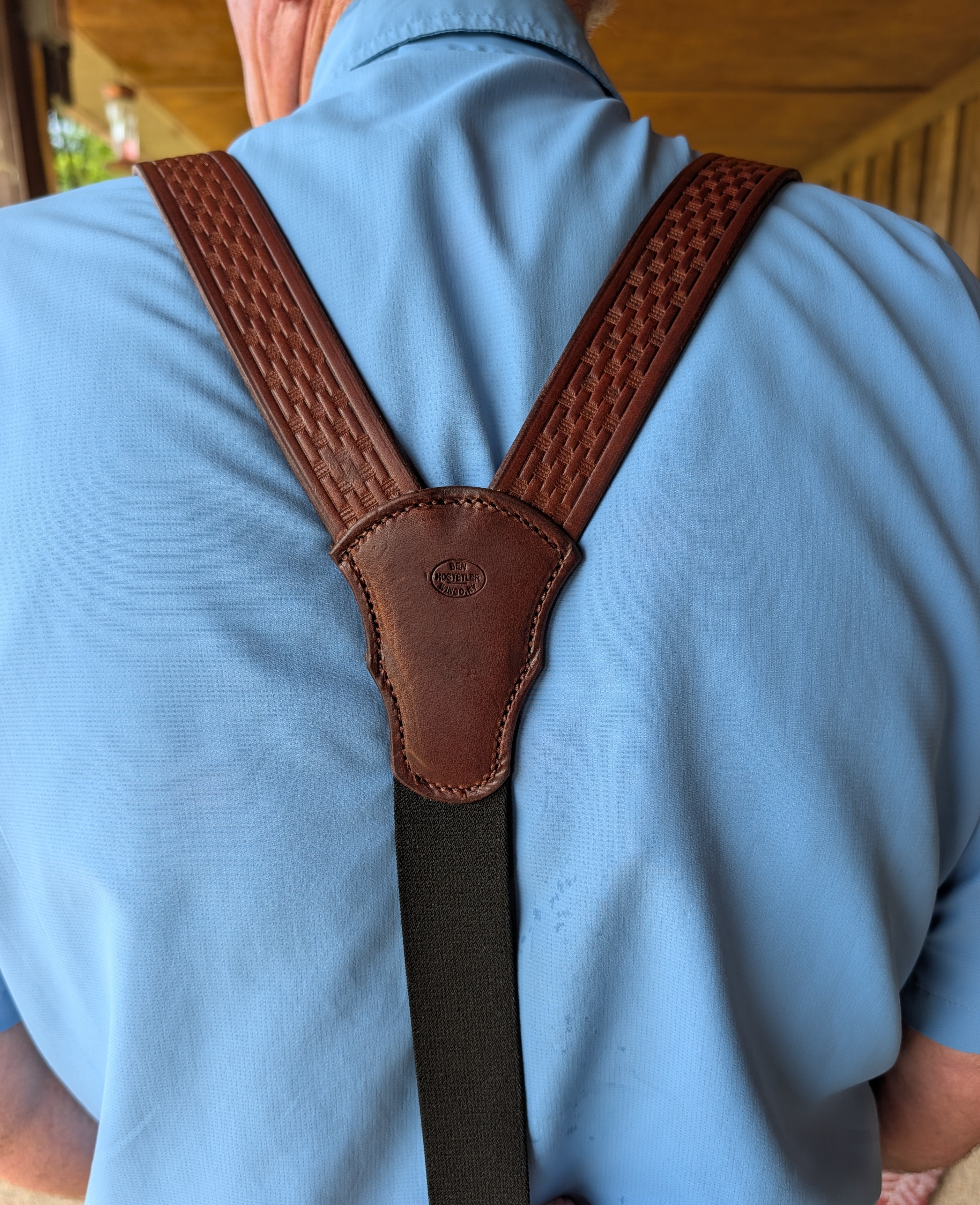 Rear Y-back view of brown basket stamped genuine bridle leather suspenders with black elastic back strap.