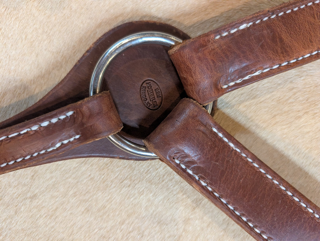Up-close of Handcrafted Herman Oak Leather Montreal breast collar with Ben Hostetler maker stamp 