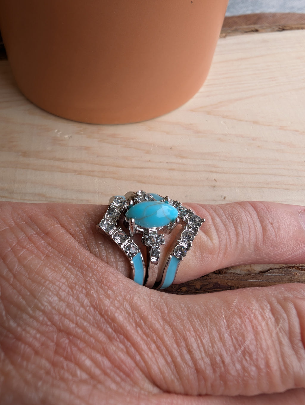 Western-style sterling silver ring displayed on rustic wood background