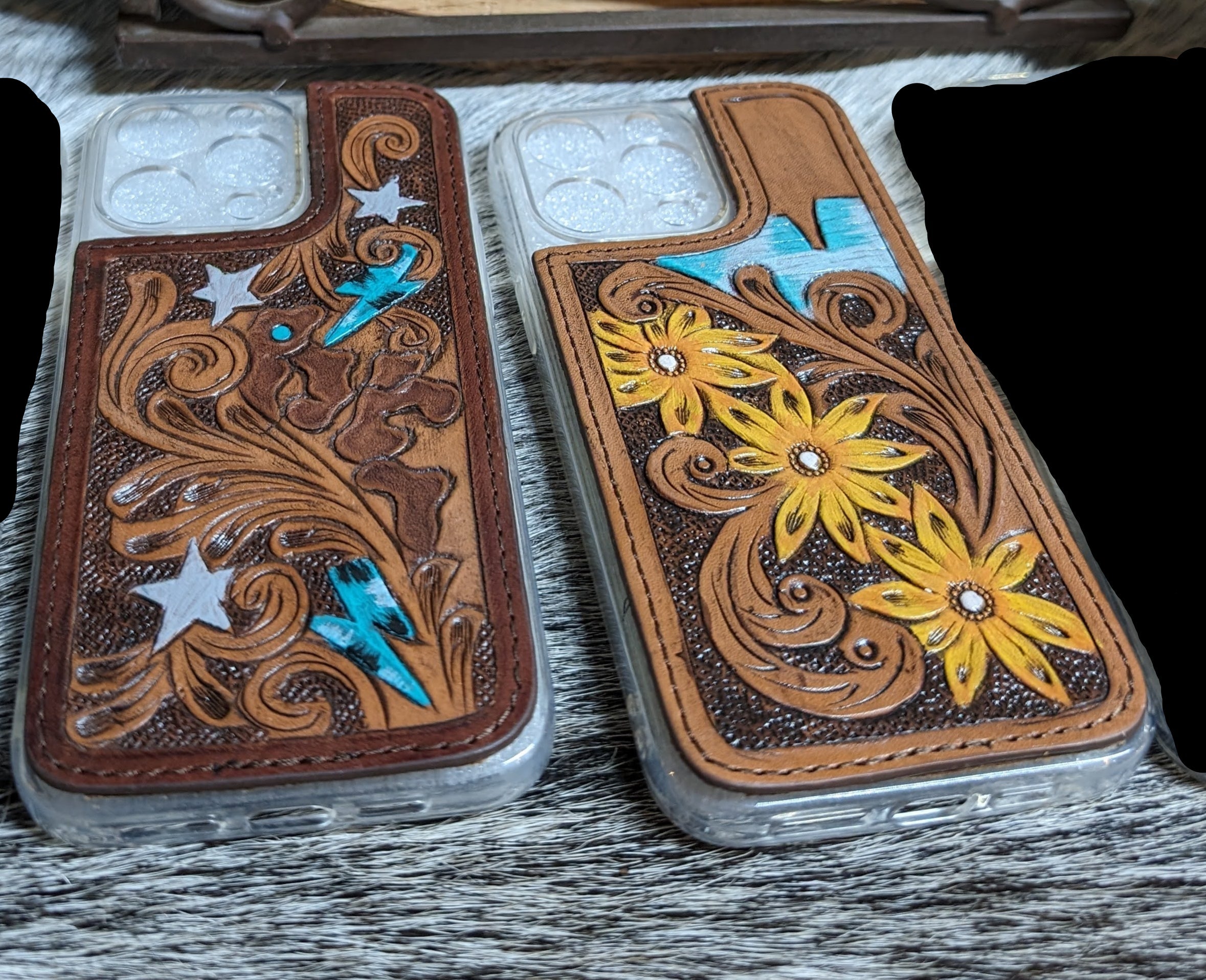 Two decorative phone cases with intricate designs on a wooden surface, featuring 'rm-brand.com' branding.