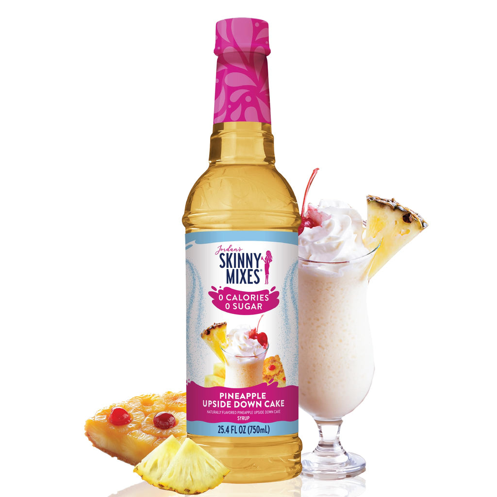 Jordan's Skinny Mix Sugar Free Pineapple Upside Down Cake Syrup with a frozen drink, whipped cream, and pineapple on the rim