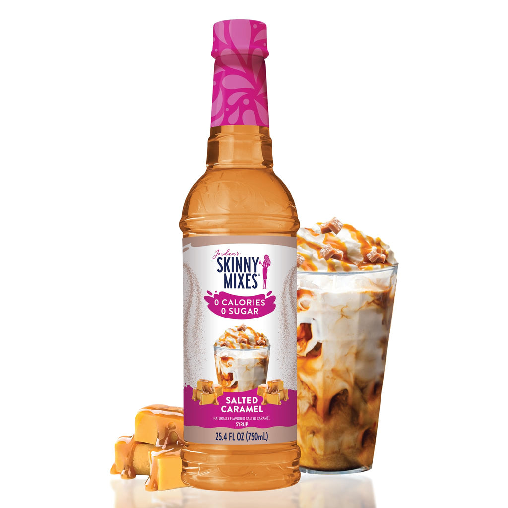 A bottle of Jordan's Skinny Mix with Salted Caramel flavor, alongside a iced coffee in a glass, with caramel pieces.