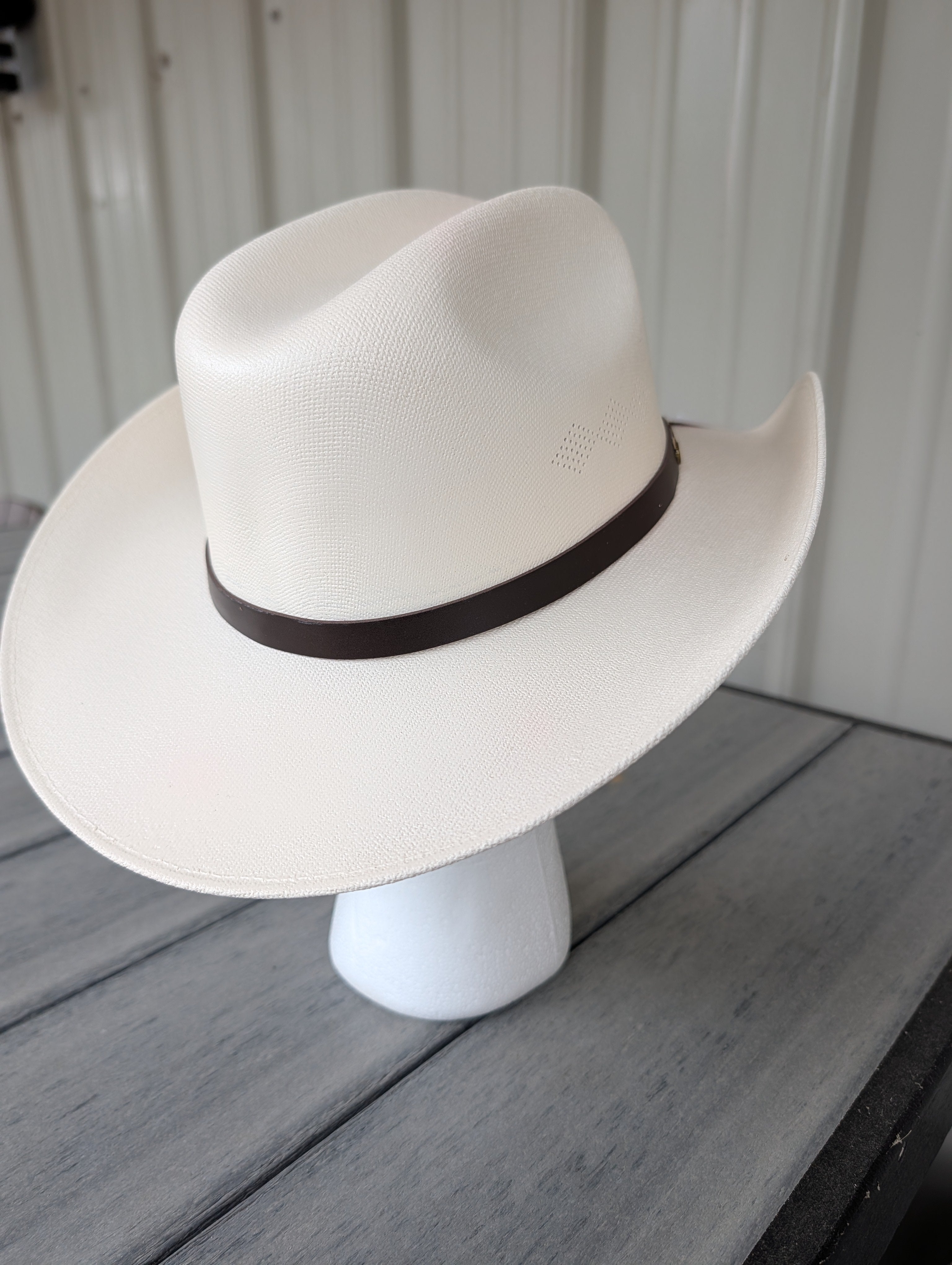 Back view of a classic kids western cowboy hat with a dark brown hat band.