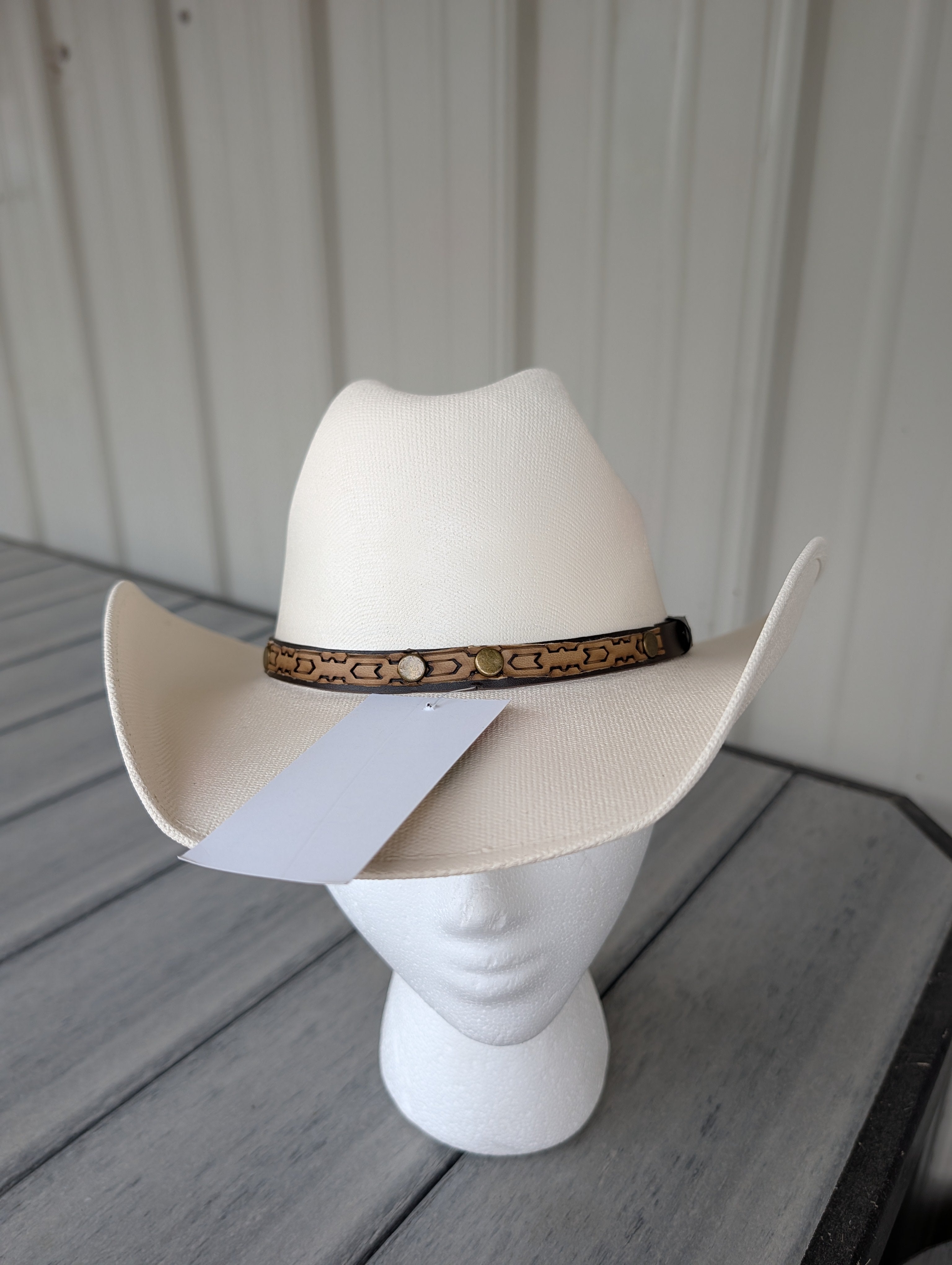 Front view of a classic kids Western cowboy hat with a decorative hat band.