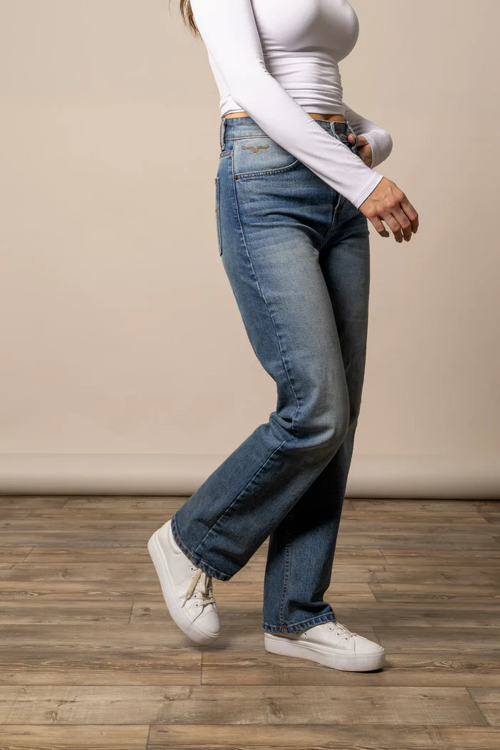 Kimes Ranch  blue jeans in the style Mia and a white long-sleeve shirt on a wooden floor