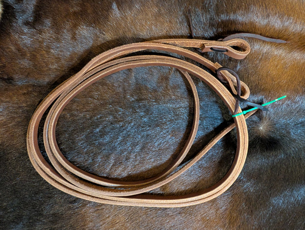 A pair of light oiled leather pony reins.