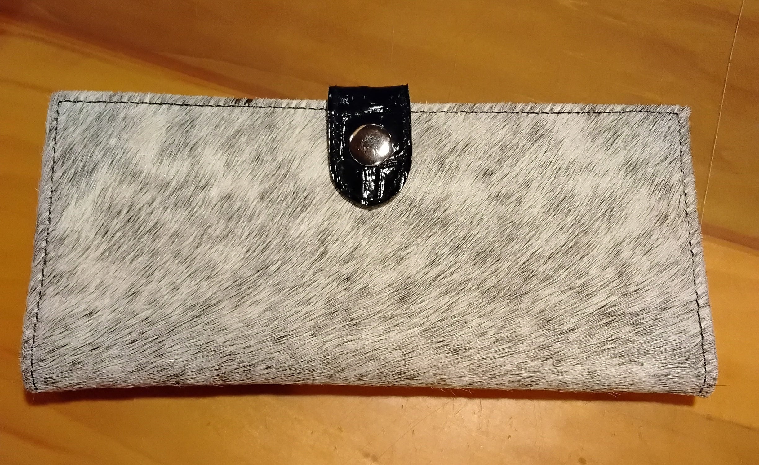 cowhide checkbook  wallet with a light speckled color