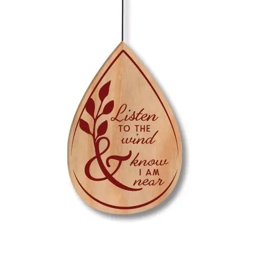 Wooden teardrop-shaped ornament with engraved text 