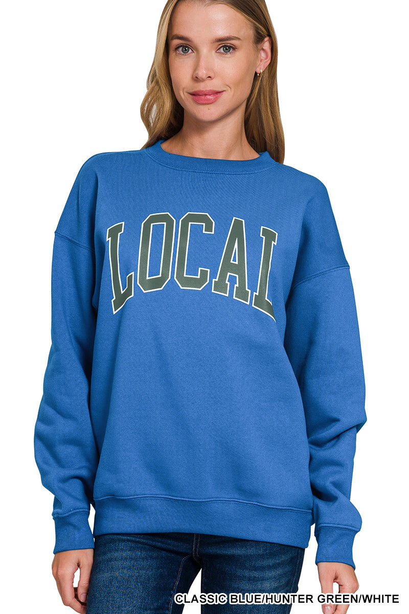 Lady wearing a blue sweatshirt with LOCAL on the front.