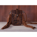 Brown leather crossbody bag with fringes on a gray surface and brown background