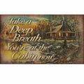 Cabin in a forest with a scenic view and text 'Take a Deep Breath. You're at the Cabin now.'