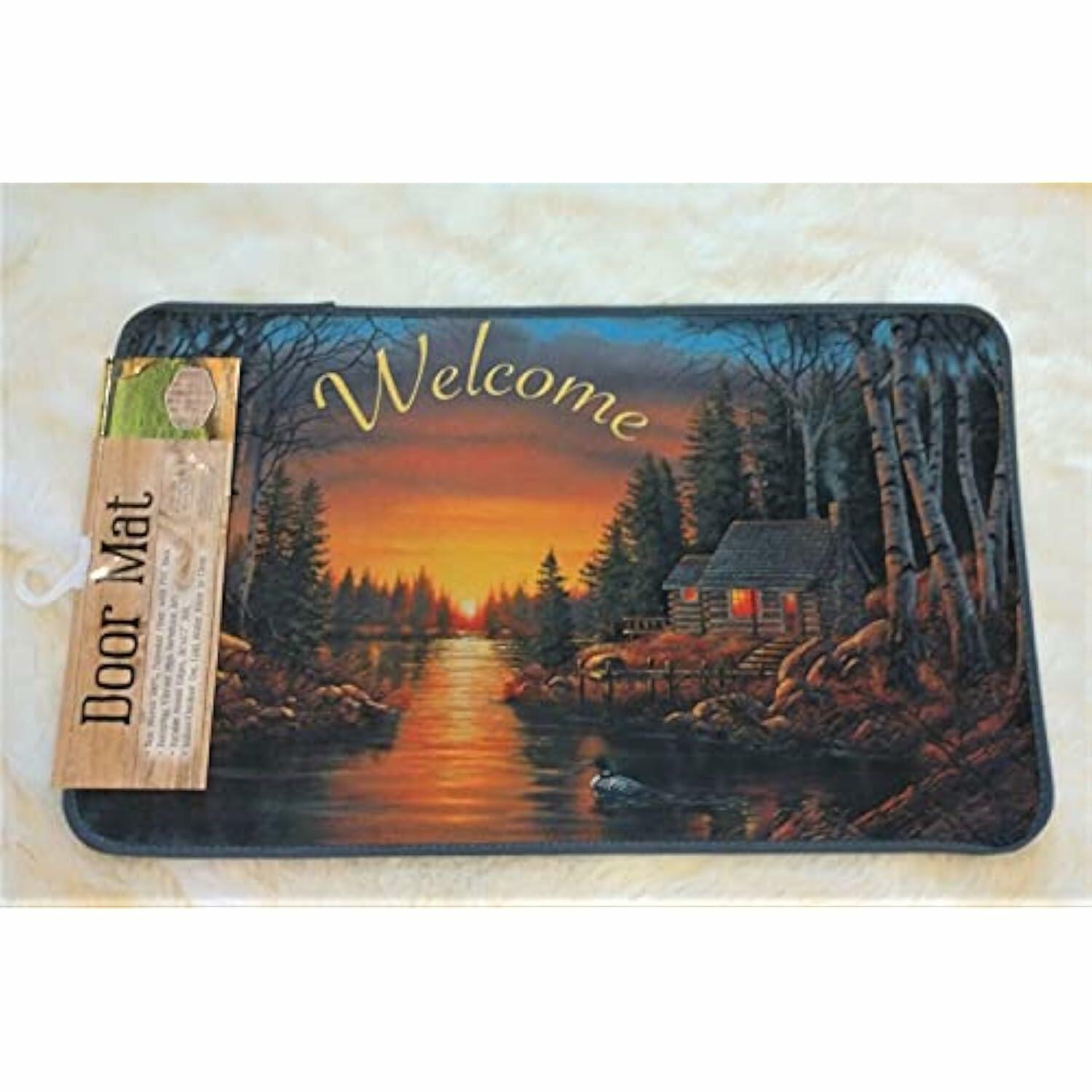 Decorative door mat with a scenic design of a cabin by a lake and the word 'Welcome'.