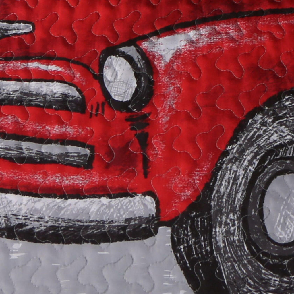 Close-up of a red truck illustration with black and white details on a textured surface.
