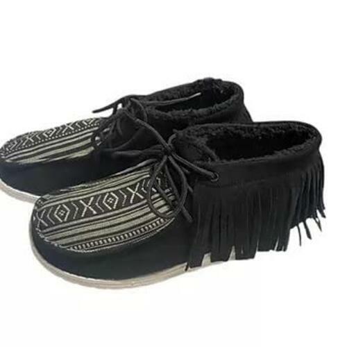 Black moccasin-style shoes with fringe and patterned sole on a white background