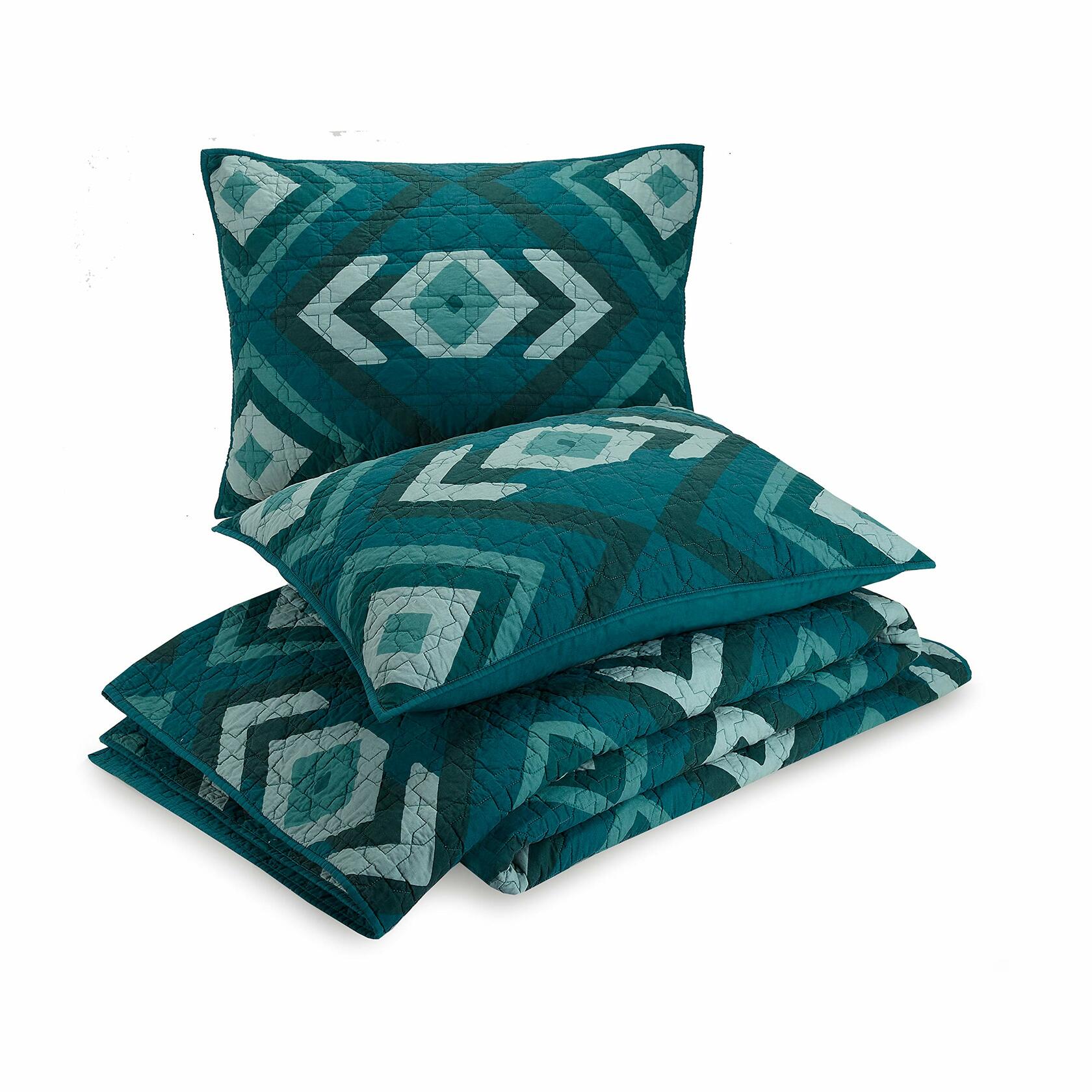Teal quilt and pillow set with geometric pattern on a white background