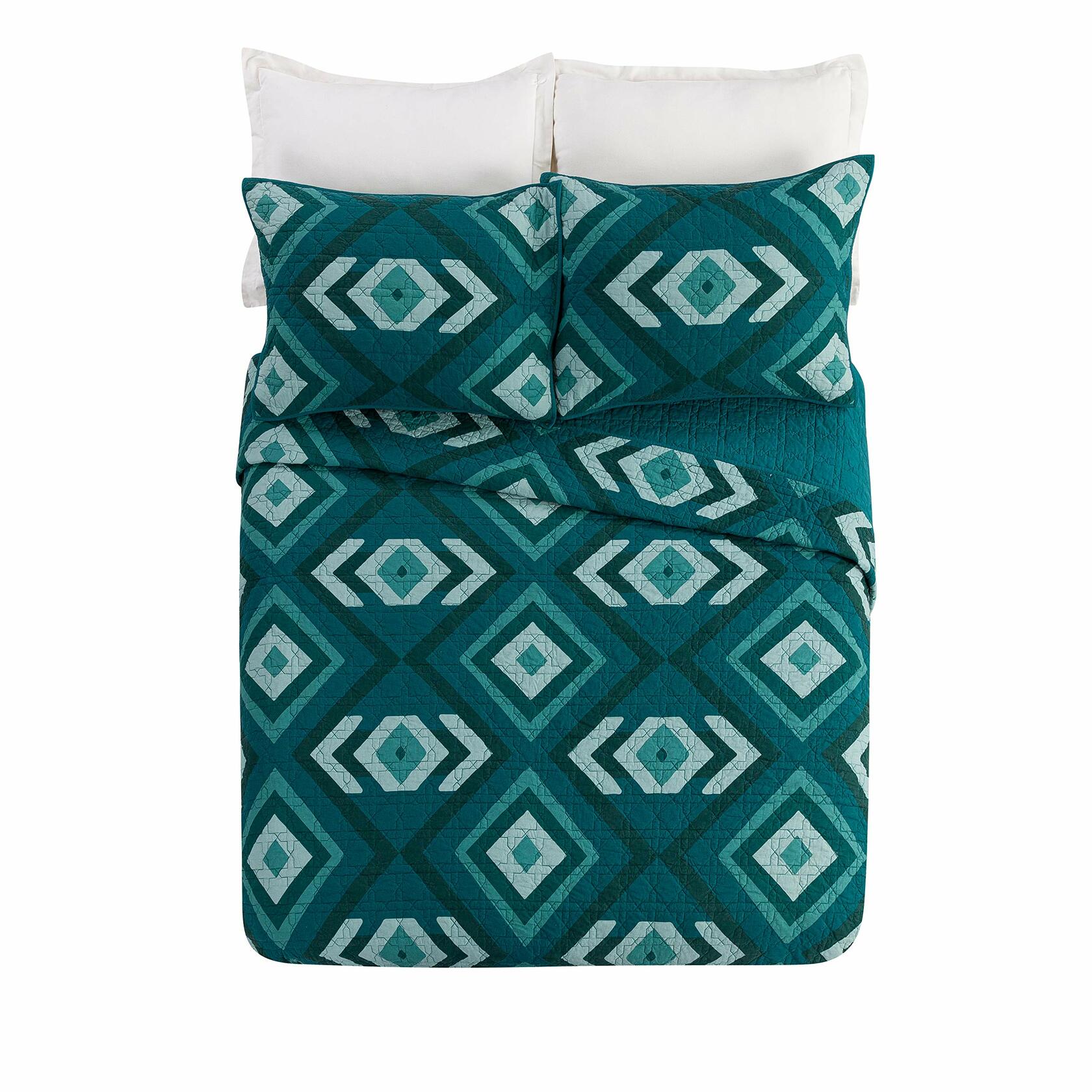 Teal and white geometric patterned bedding set with pillows on a white background