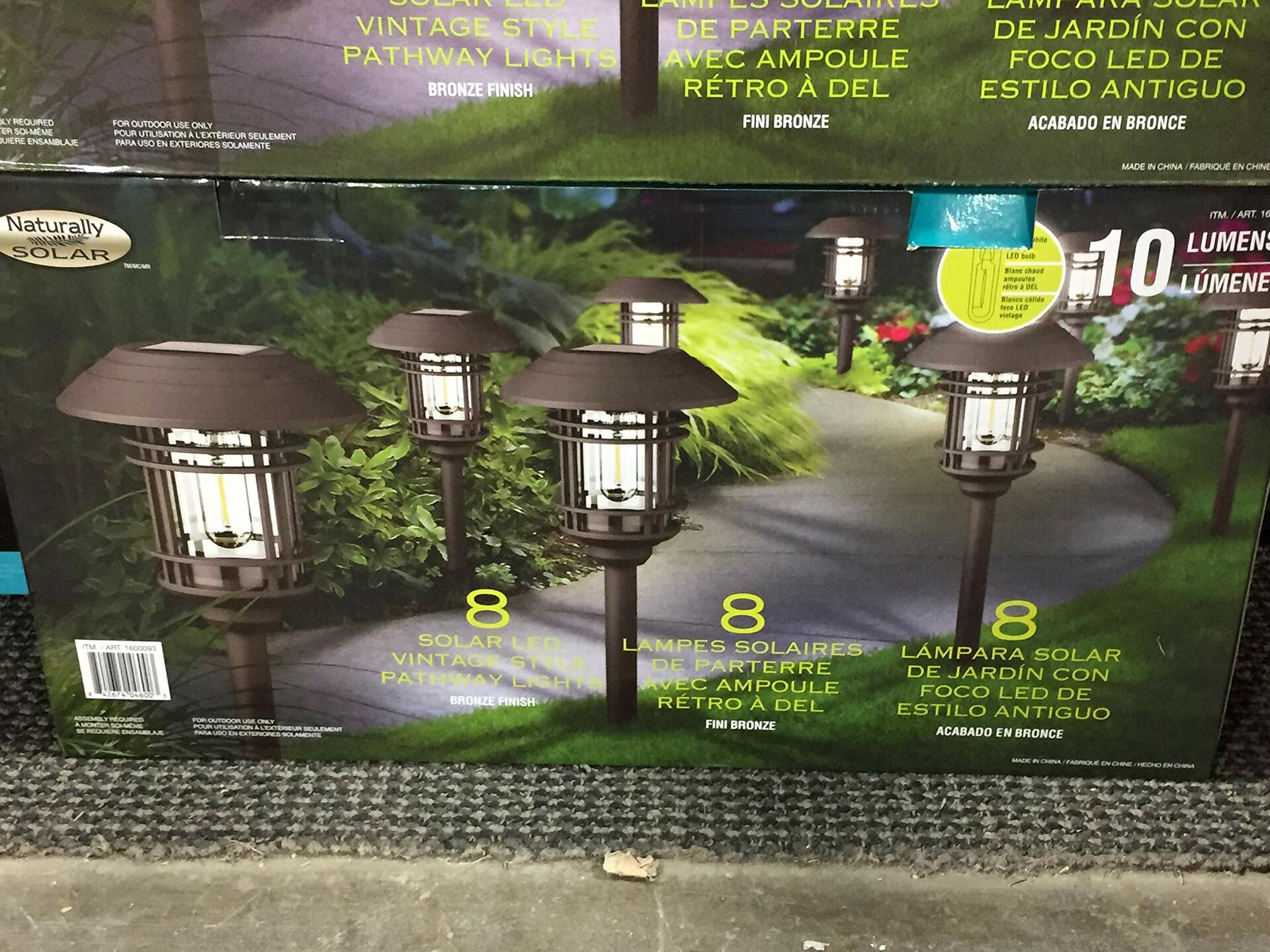Packaging of solar pathway lights with product images and text on a store shelf.