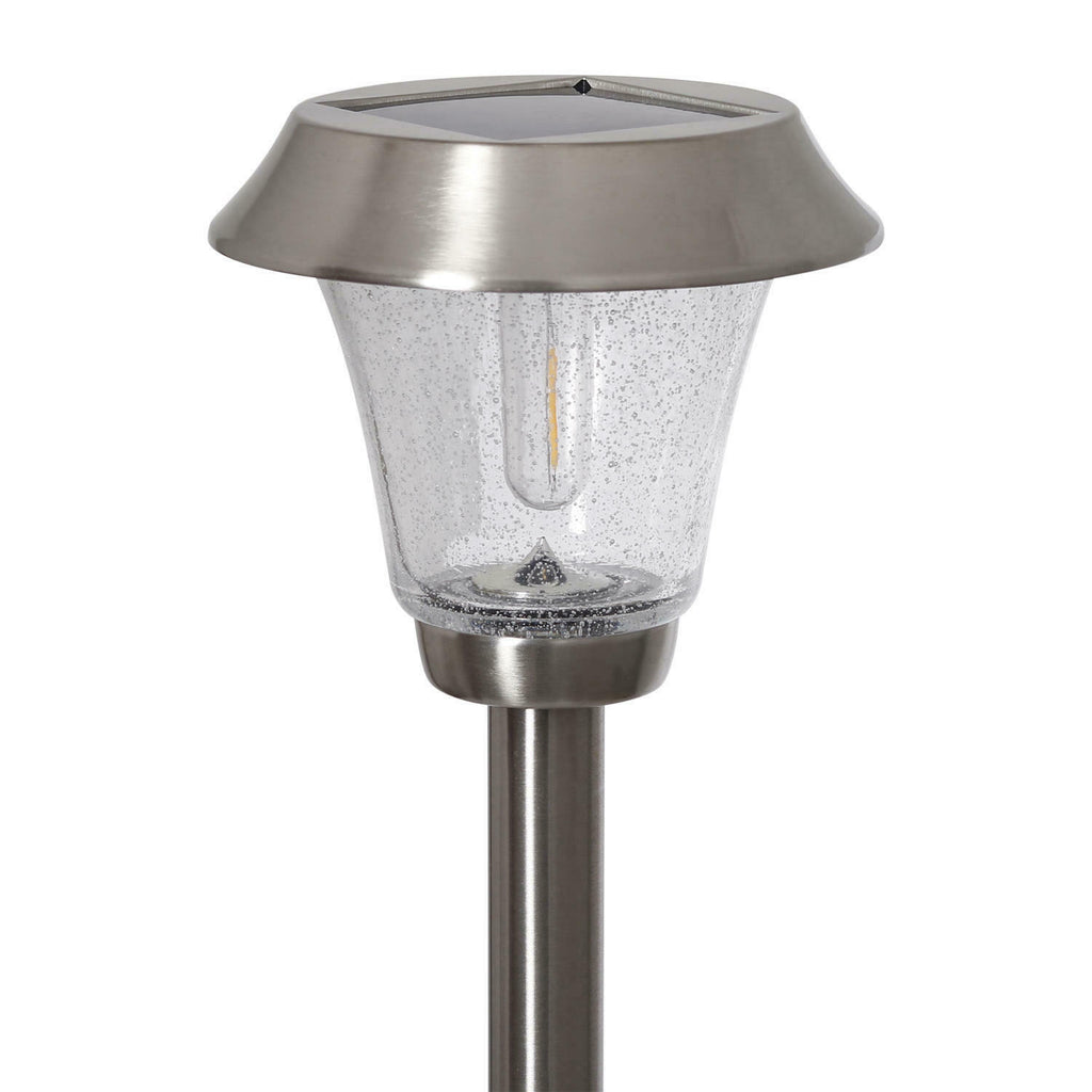 Solar-powered outdoor lamp with clear glass shade on a white background