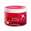 Red jar of cleansing shower jelly with floral designs on a white background