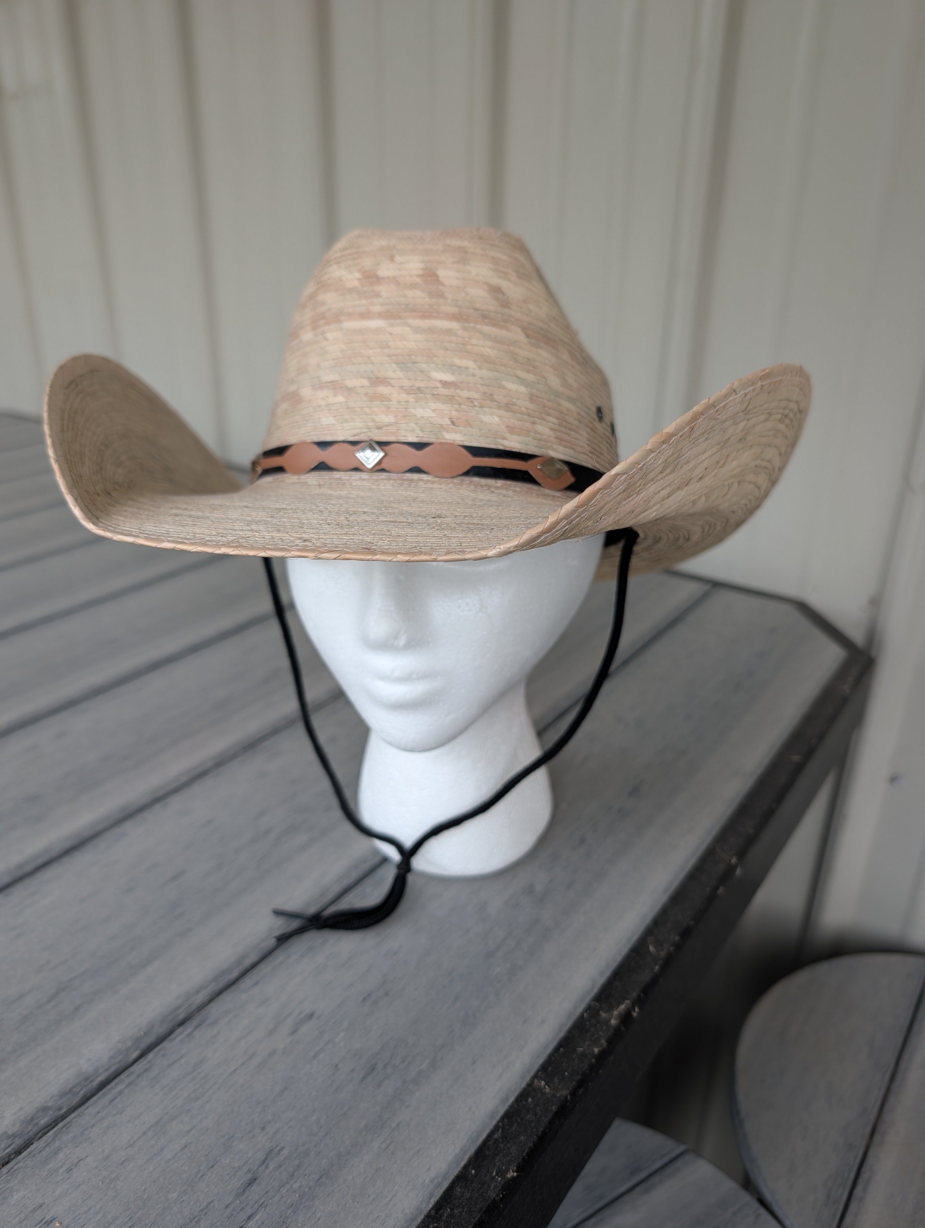 Light palm leaf cattleman cowboy hat with diamond accent hat band and black stampede string