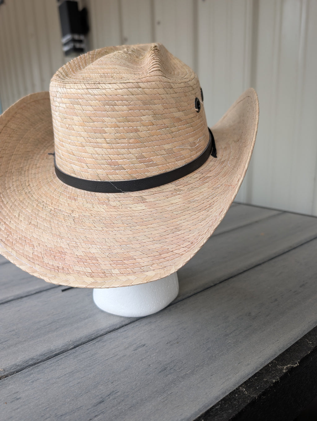 Back view of natural palm leaf cowboy hat showing crown shape and black band