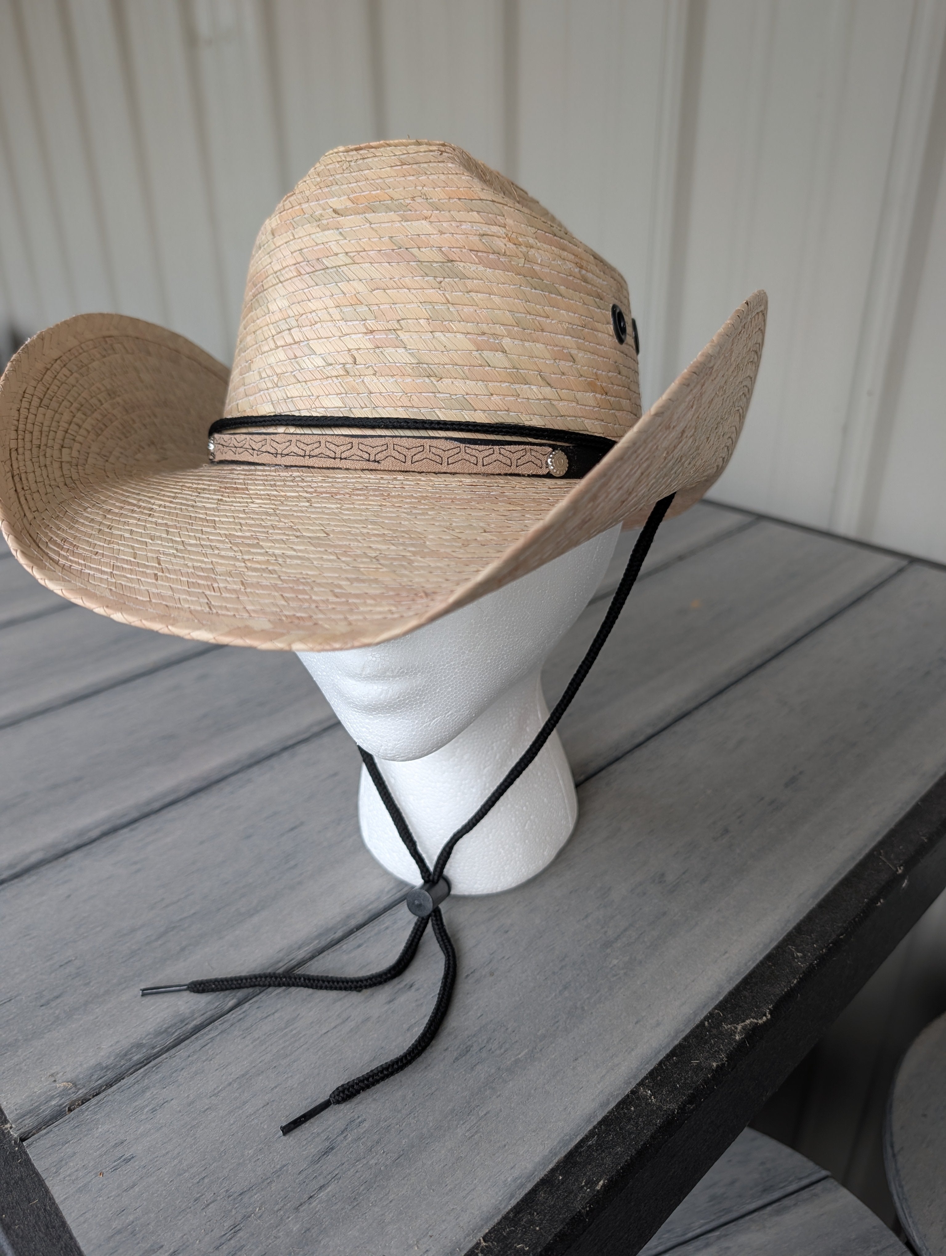 Unisex natural straw palm leaf cowboy hat on white mannequin display